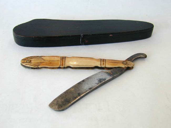 A 19th century Straight Razor with Carved Bone Handle and Original Wooden Carrying case