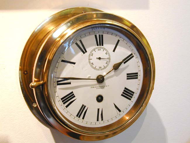 A late 19th century Ship's Bulkhead Clock signed "Hirsbrunner & Co., Shanghai"