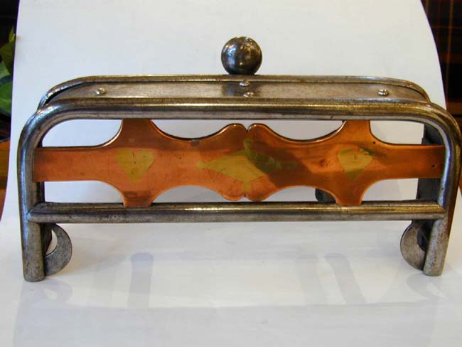 A Miniature 19th Century Polished Steel Fireplace Trivet With Inlaid Brass and Copper Decoration