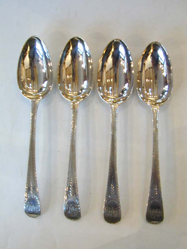 A Set of Four Engraved Bright-Cut Sterling Silver Tablespoons by HESTER BATEMAN, London 1786.