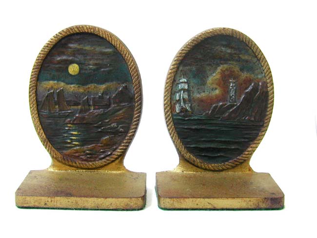 A Pair of BRADLEY & HUBBARD Antique Bookends ca. 1910 depicting a Coastal Village in the Moonlight