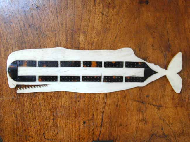 A charming 19th century   Cribbage Board carved from a whales' jawbone and inlaid with tortoiseshell  