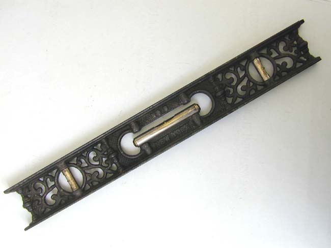 An Antique Decorative Cast-Iron Level Marked "M.W. ROBINSON, No. 8, New York, circa 1870