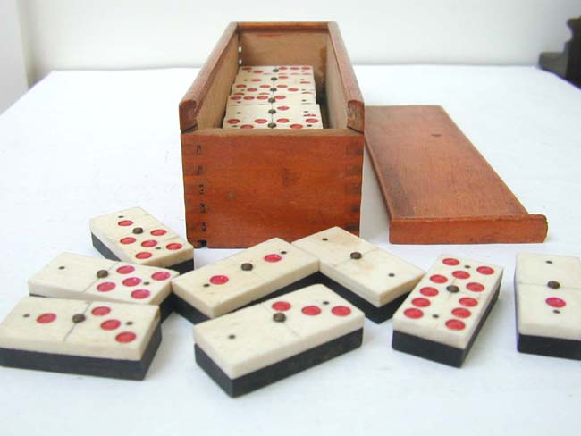 An Unusual Cased Set of 24 Bone and Ebony Dominoes with Red Dots circa 1890