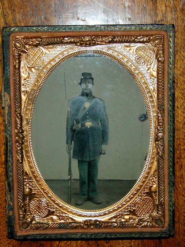 A Civil War Tinted Ambrotype Image of a full standing Union Private with musket, bayonet