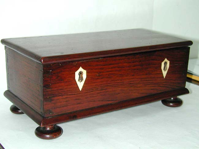 A Small 19th Century Dovetailed Mahogany Box on Bun Feet with Ivory Key Escutcheons
