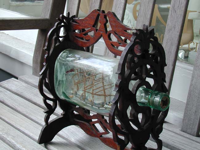A Nice 19th century Ship-in-a Bottle in an elaborately carved fretwork frame circa 1875. — image 2