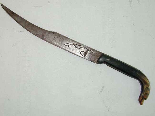 A Revolutionary War period Knife with 7" curved blade marked 'P' and 'C' and a horn mounted grip with dog's head pommel circa 1760.