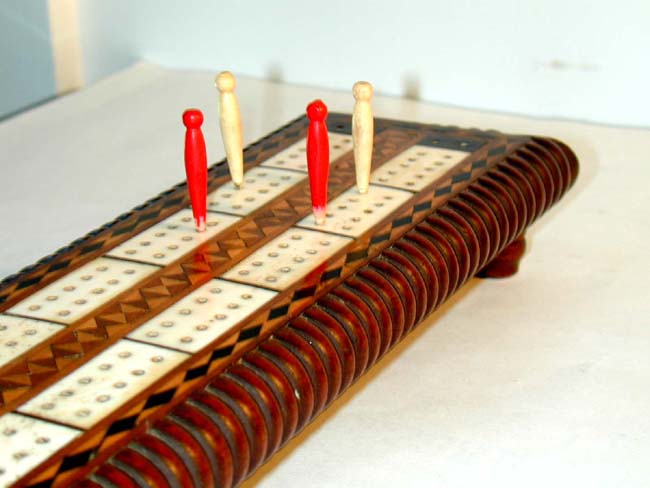 An Attractive Antique Ivory Inlaid Walnut Cribbage Board with Four Ivory Markers circa 1875