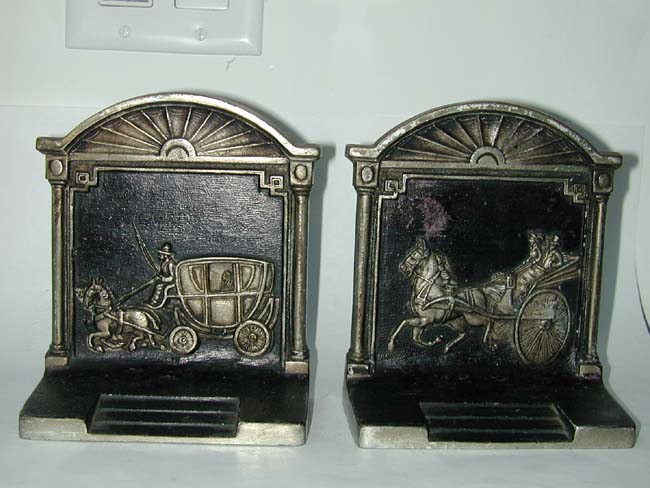 A pair of Antique Bookends by Bradley & Hubbard depicting a stagecoach and a carriage.