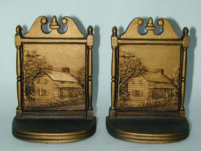 A good pair of Antique Bookends by Bradley& Hubbard circa 1920 depicting a log cabin