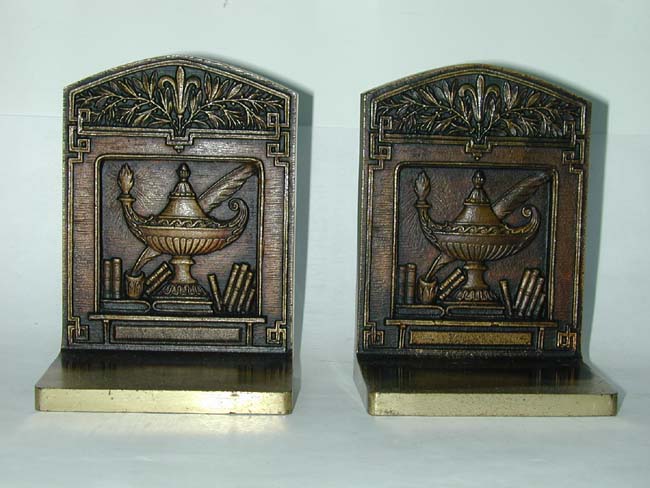 a Pair of Antique Bookends by Bradley & Hubbard depicting the symbols of Learning