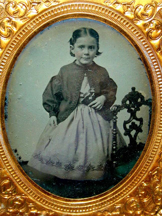 A mid 19th century Ambrotype of a Beautiful Little Girl holding a doll