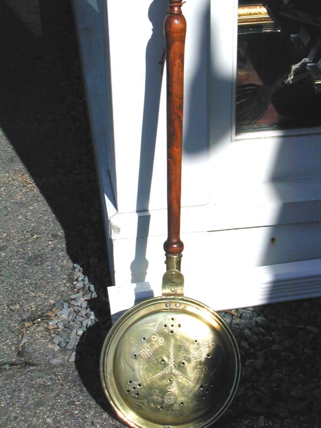 An Early 19th century Brass Bed Warmer With Later Turned Cherry Handle