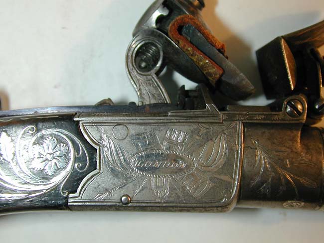A Museum Quality Pair of Flintlock Pocket Pistols inlaid with Gold and Silver by John George Lacy, London, circa 1810-1814. — image 4