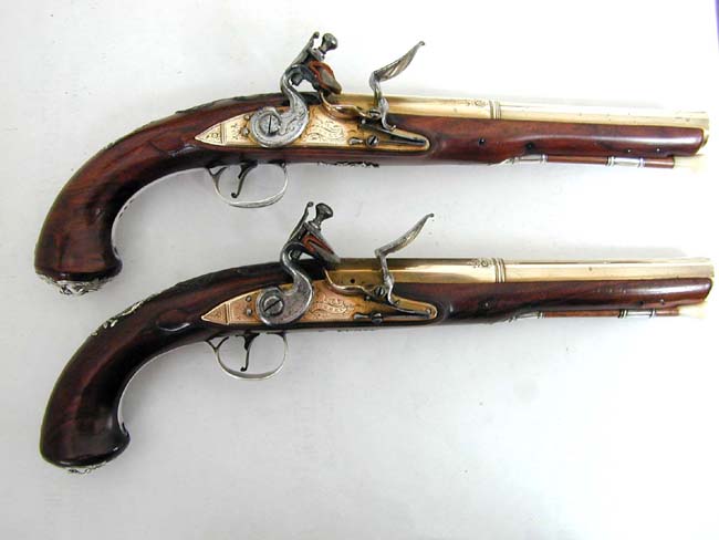 An Exceptionally fine and rare pair of English Naval Officer's Silver Mounted Brass Barrelled Flintlock Pistols by Joseph Bunney, London, 1776.
