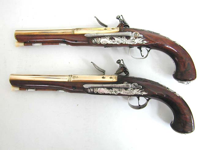 An Exceptionally fine and rare pair of English Naval Officer's Silver Mounted Brass Barrelled Flintlock Pistols by Joseph Bunney, London, 1776. — image 2