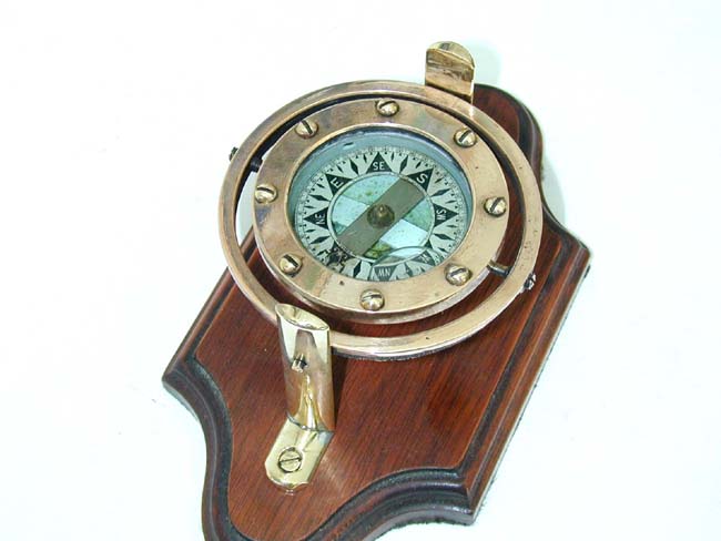 A Charming Small Brass and Copper Dory Compass circa 1910, mounted on a mahogany stand.