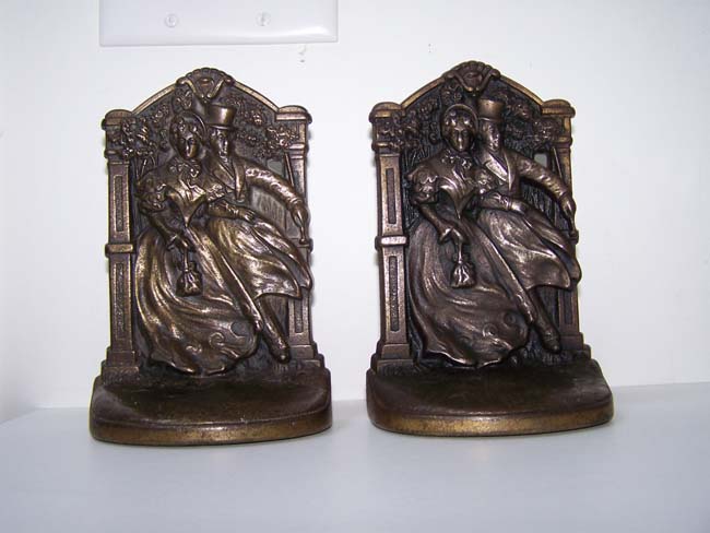 A pair of Antique Bookends by Judd & Co. circa 1924 depicting a Victorian couple walking in the wind