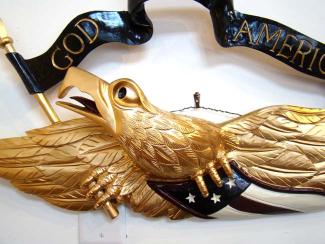 A fabulous contemporary carved American eagle plaque with banner reading "GOD BLESS AMERICA"
