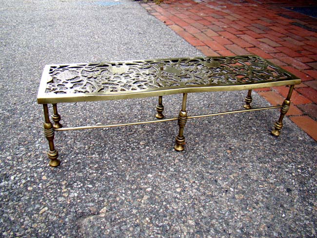 A fine all brass Victorian fireplace trivet circa 1860-1890 in the beehive and grape vine pattern