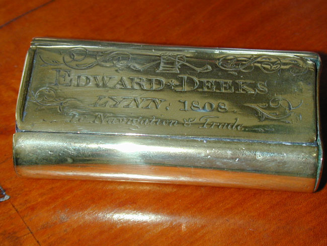 An Engraved Brass Tobacco Box inscribed "Edward Deeks, Lynn, 1808, To Navigation and Trade." The reverse side inscribed "May Poverty never pinch us Nor riches make us proud."