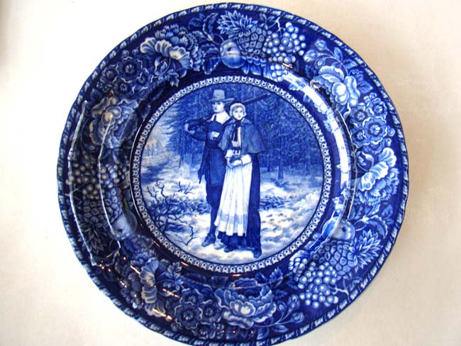 An historic souvenir plate circa 1908 depicting pilgrims John Alden and Priscilla