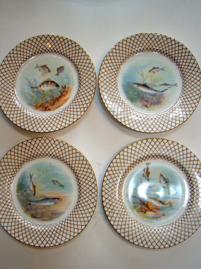 A beautiful set of four hand painted Limoges bone china fish plates circa 1900