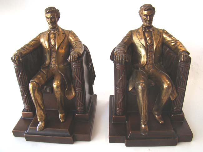 A pair of vintage bronze and brass finished Abraham Lincoln "sitting in the chair" bookends circa 1930