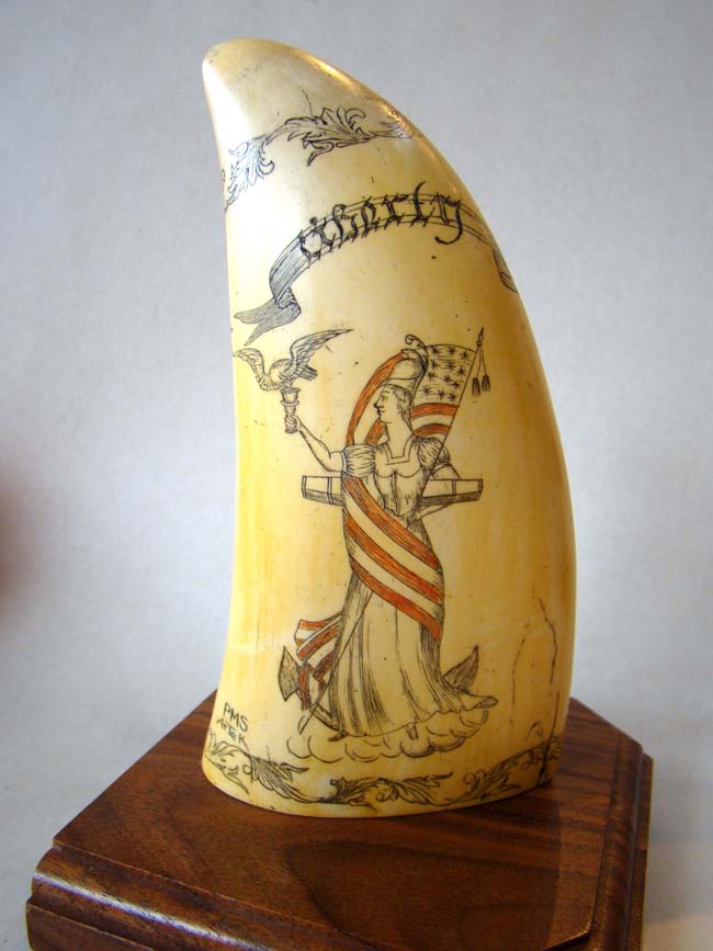 A very nice reproduction scrimshaw whale's tooth made by Artek