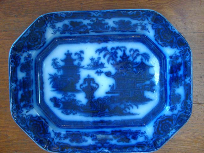 A very rare early FLOW BLUE platter in the TEMPLE pattern by Podmore Walker & Co., circa 1834-1849
