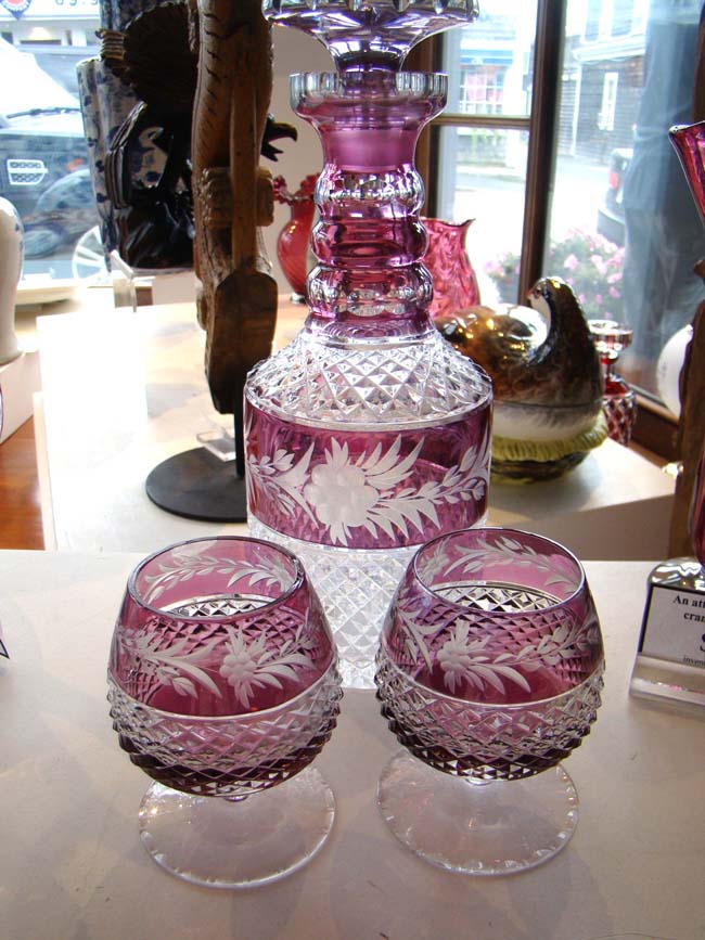 A fine Amethyst cut crystal diamond point decanter with two matching cordial glasses