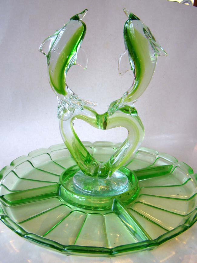 An attractive vintage green depression glass serving dish with removable double dolphin centerpiece