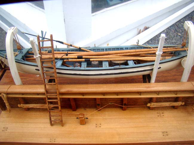 A very fine whaleboat model secured by davits to the hull of a whaling ship — image 3