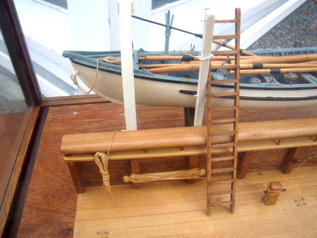 A very fine whaleboat model secured by davits to the hull of a whaling ship — image 5