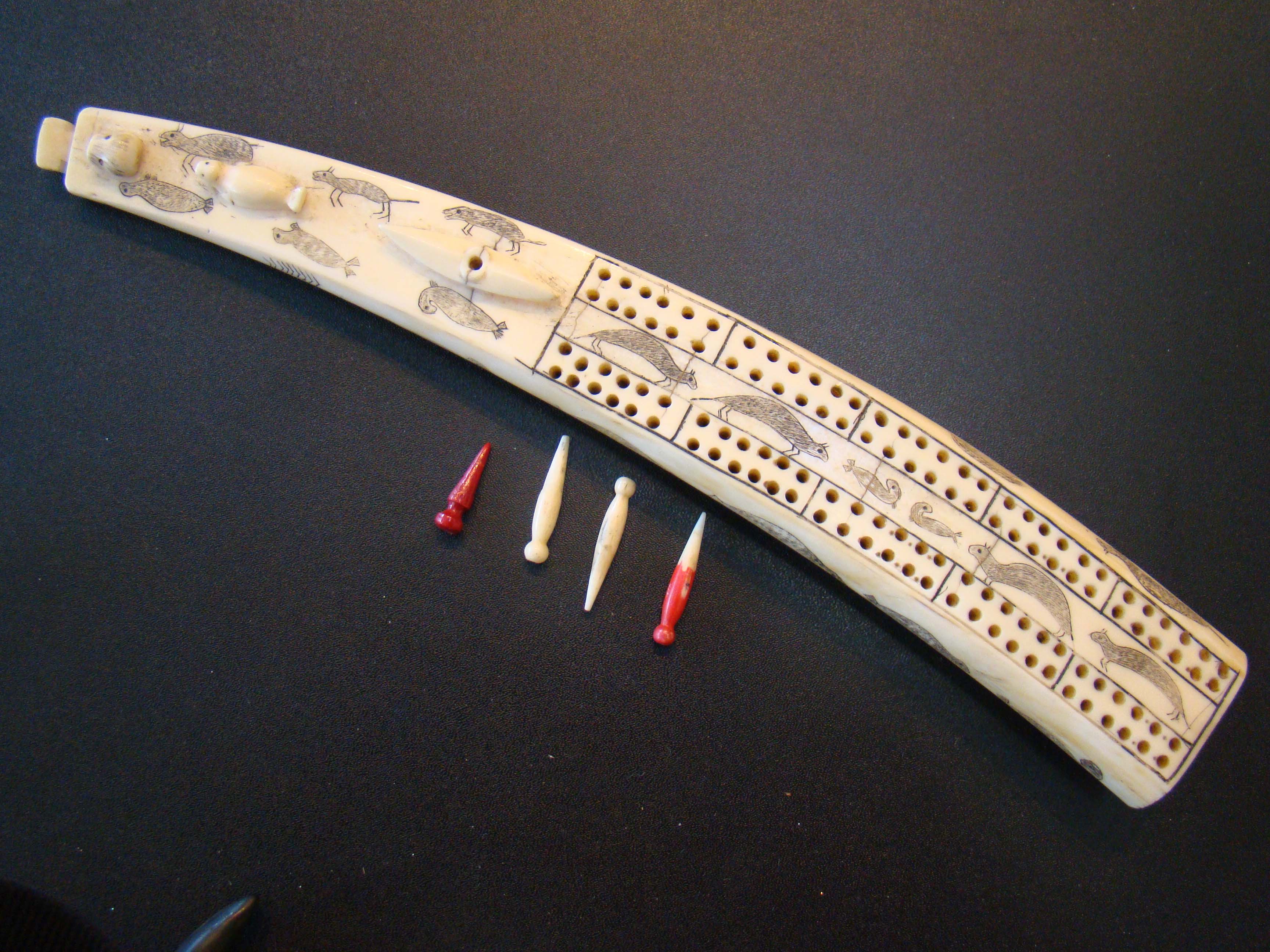 An exceptionally fine Inuit carved antique walrus tusk cribbage board — image 2