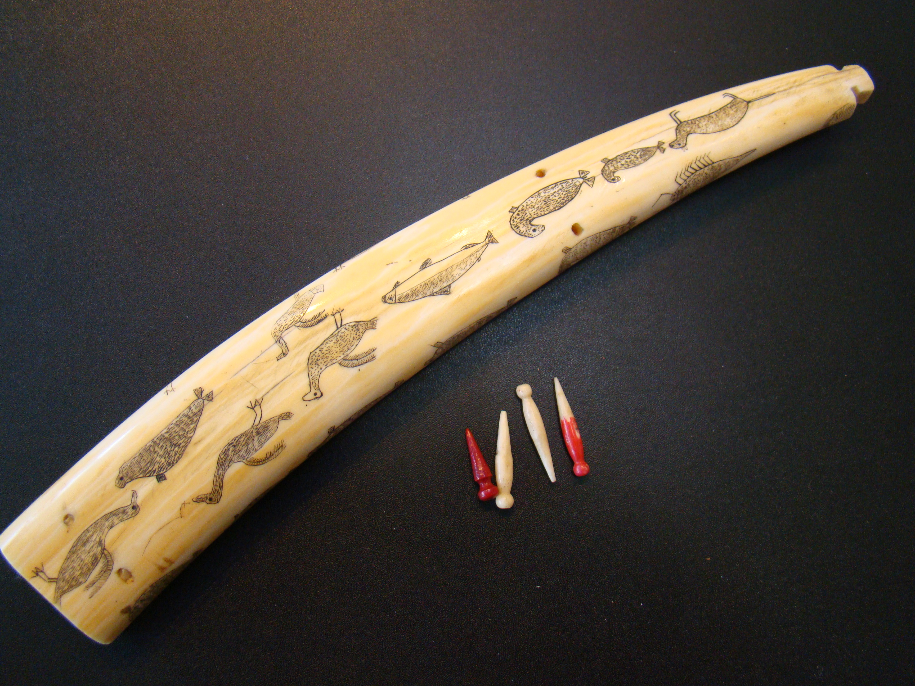 An exceptionally fine Inuit carved antique walrus tusk cribbage board