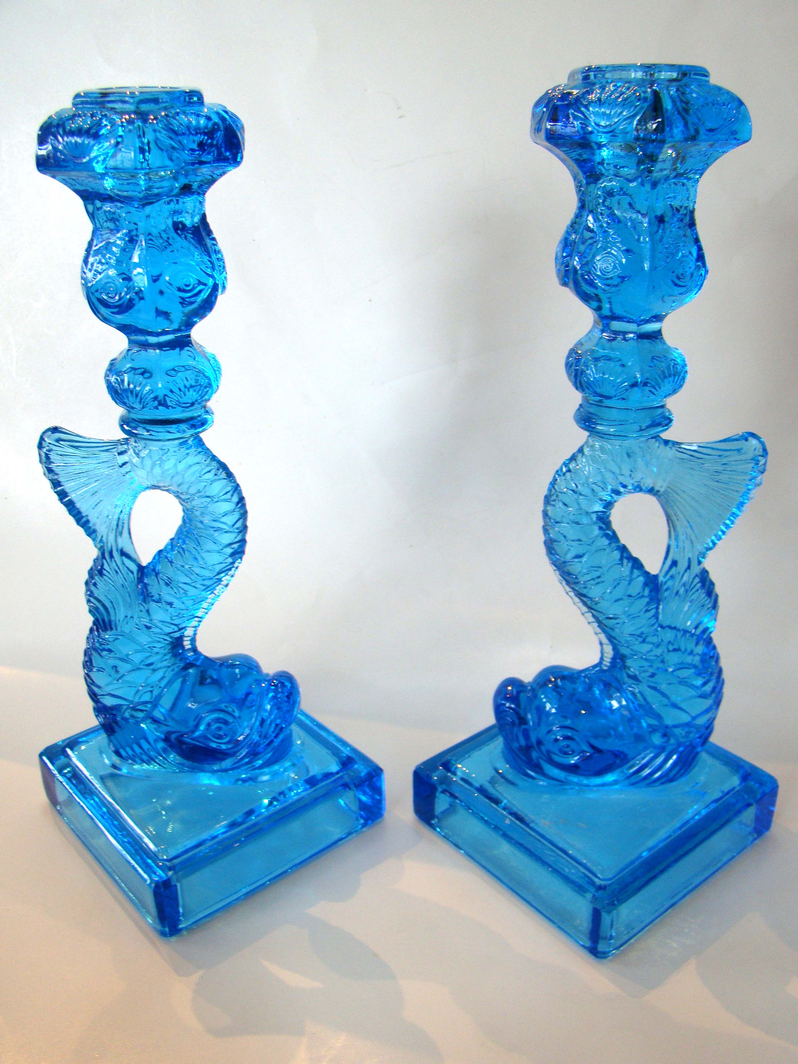 An exceptionally fine and beautiful pair of vintage Dolphin form candlesticks originally retailed by the Metropolitan Museum of Art