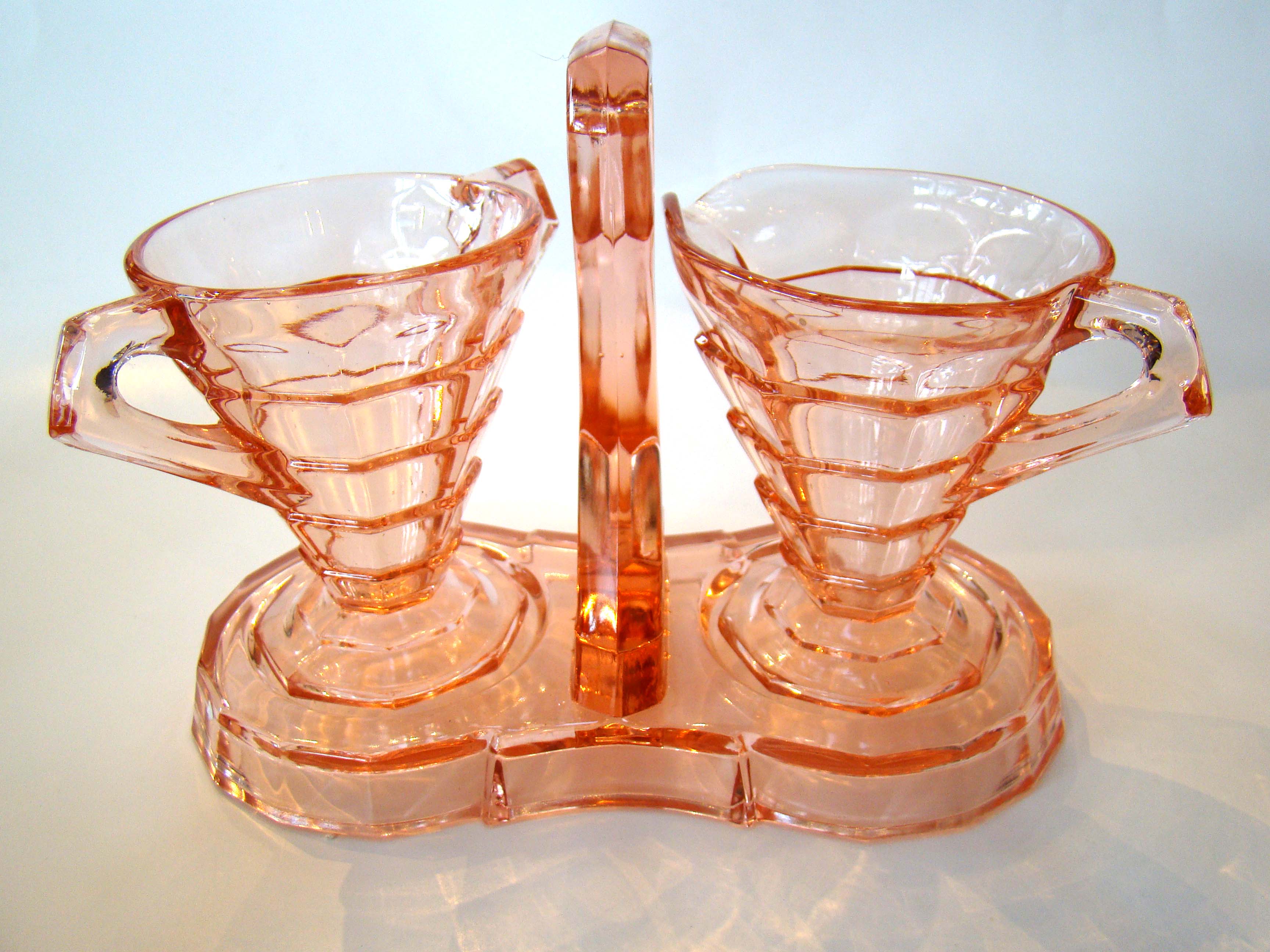 An attractive vintage pink Depression glass sugar, creamer with matching stand circa 1935