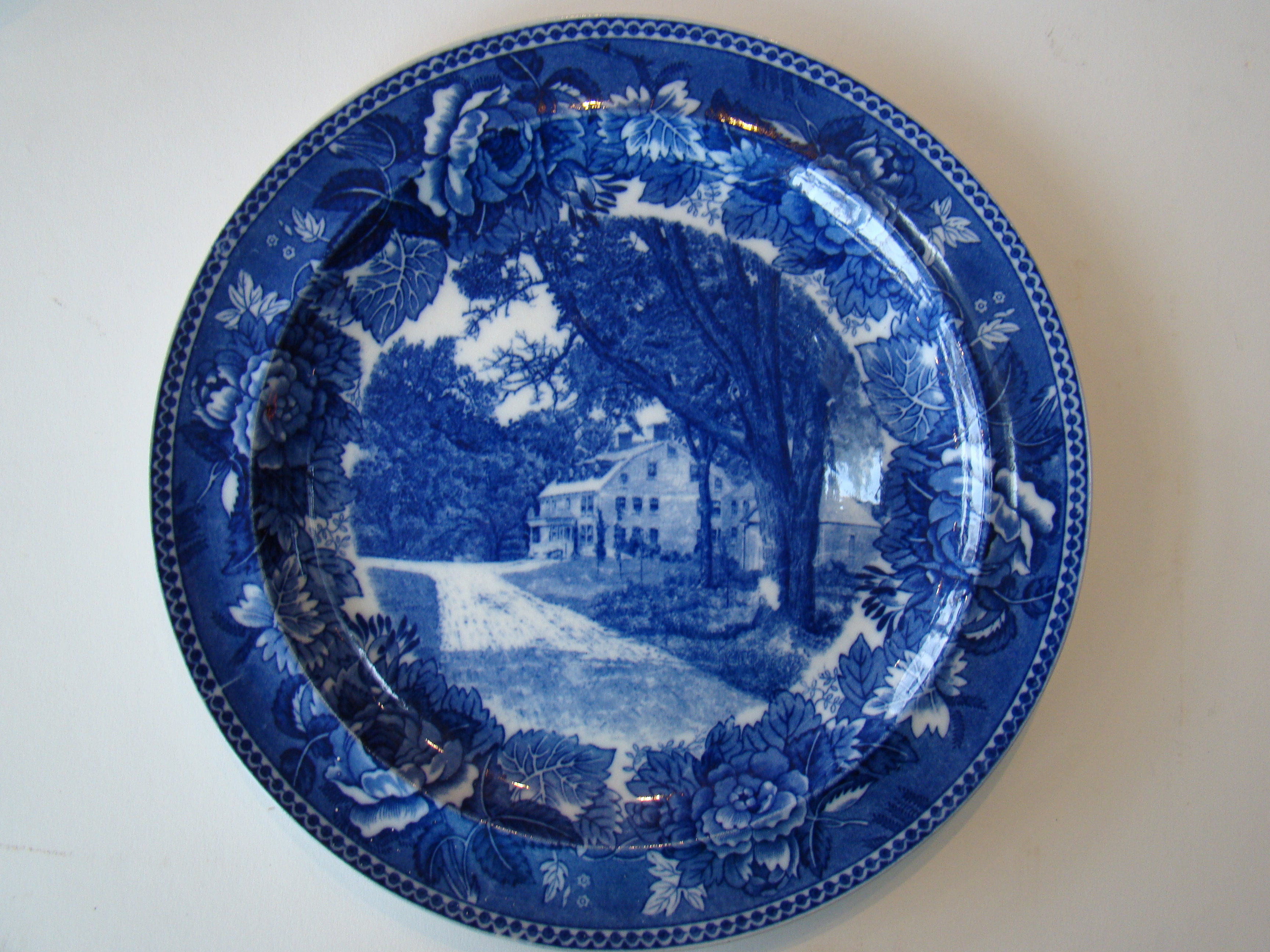 A fine late 19th century Wedgwood souvenir plate depicting Longfellow's Wayside Inn in Sudbury, Mass