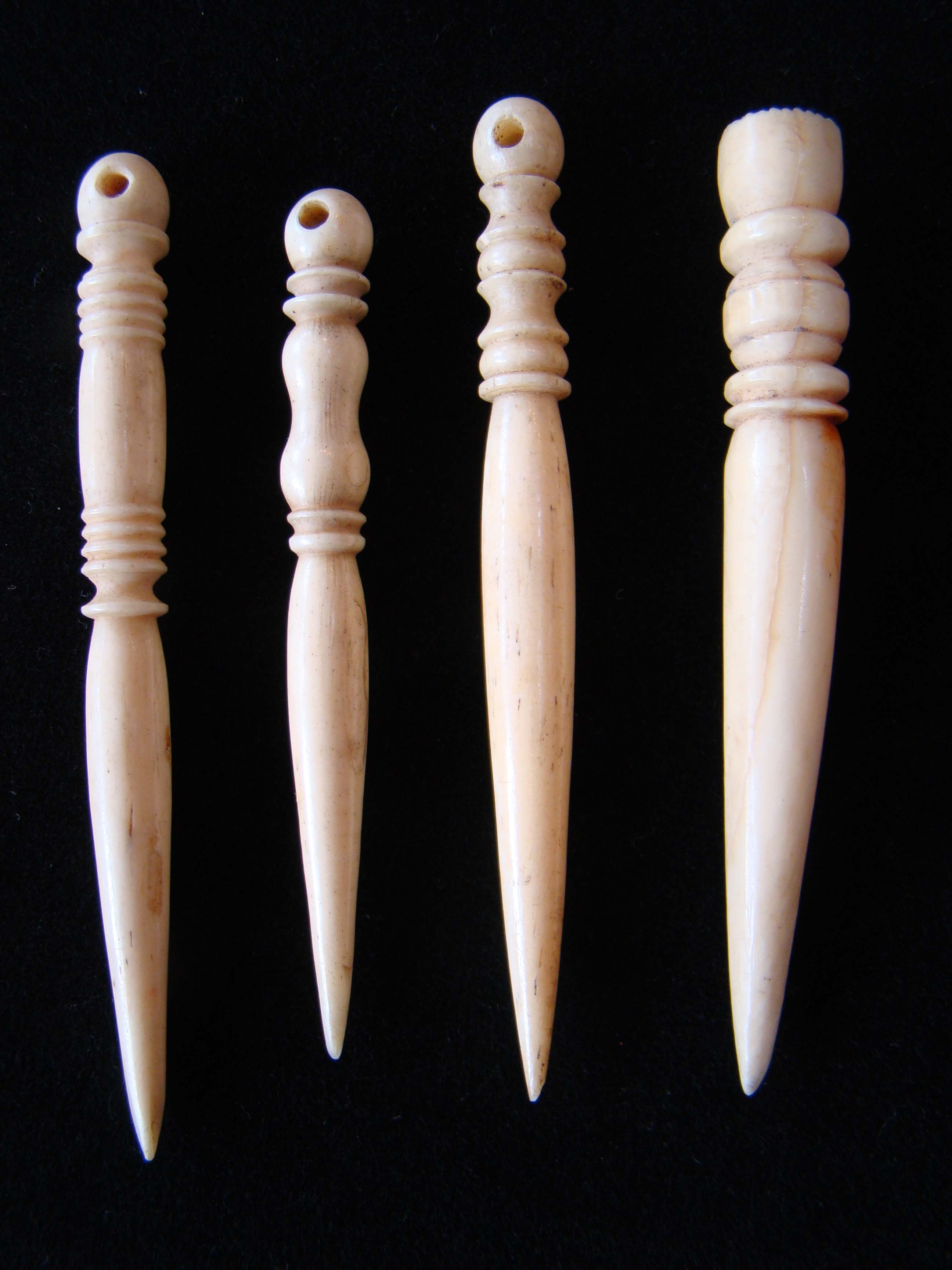 Four 19th century sailor-carved whale 'ivory' bodkins circa 1830-1880