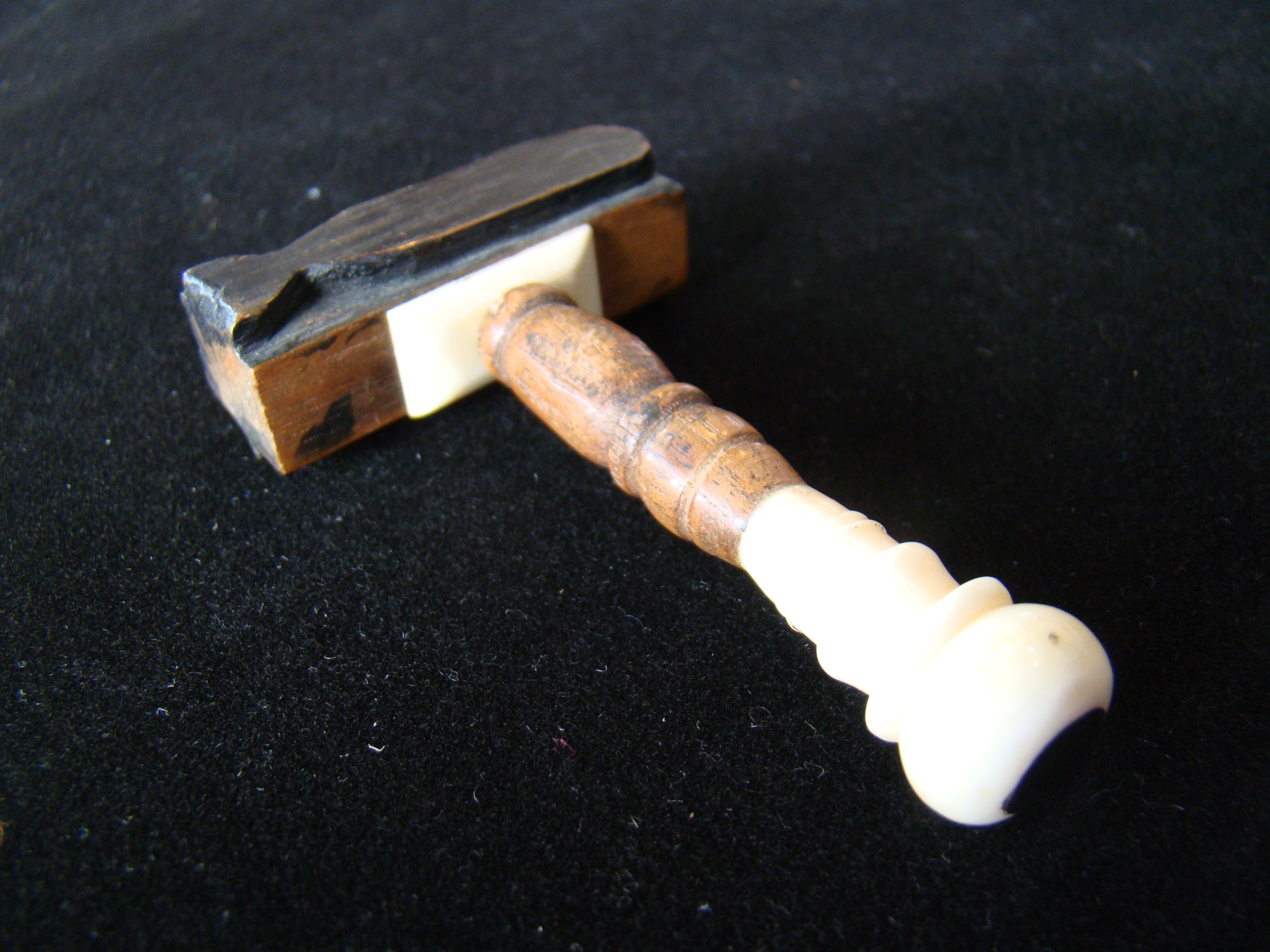 A fine whale ivory mounted whaling log book stamp having three different whale stamps