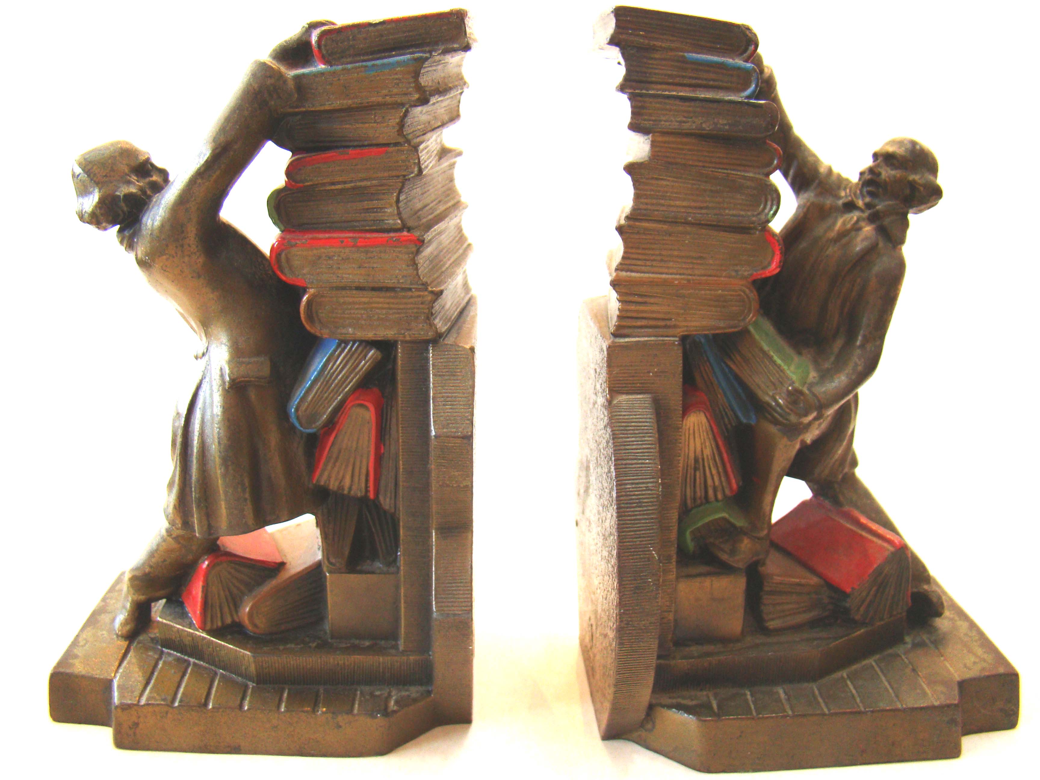 A fine pair of vintage bookends circa 1932 depicting a colonial gentleman trying to stack his books