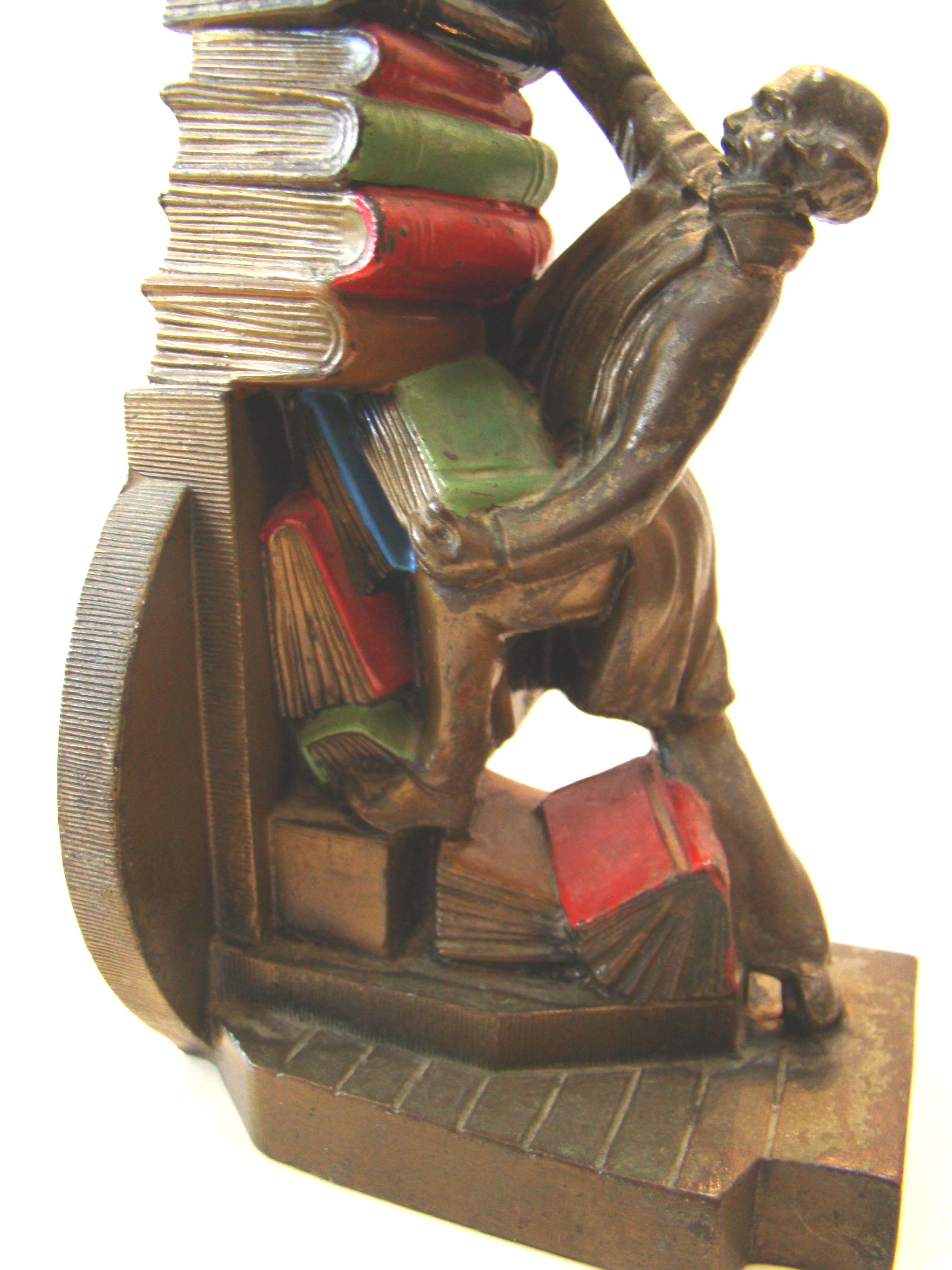 A fine pair of vintage bookends circa 1932 depicting a colonial gentleman trying to stack his books — image 2