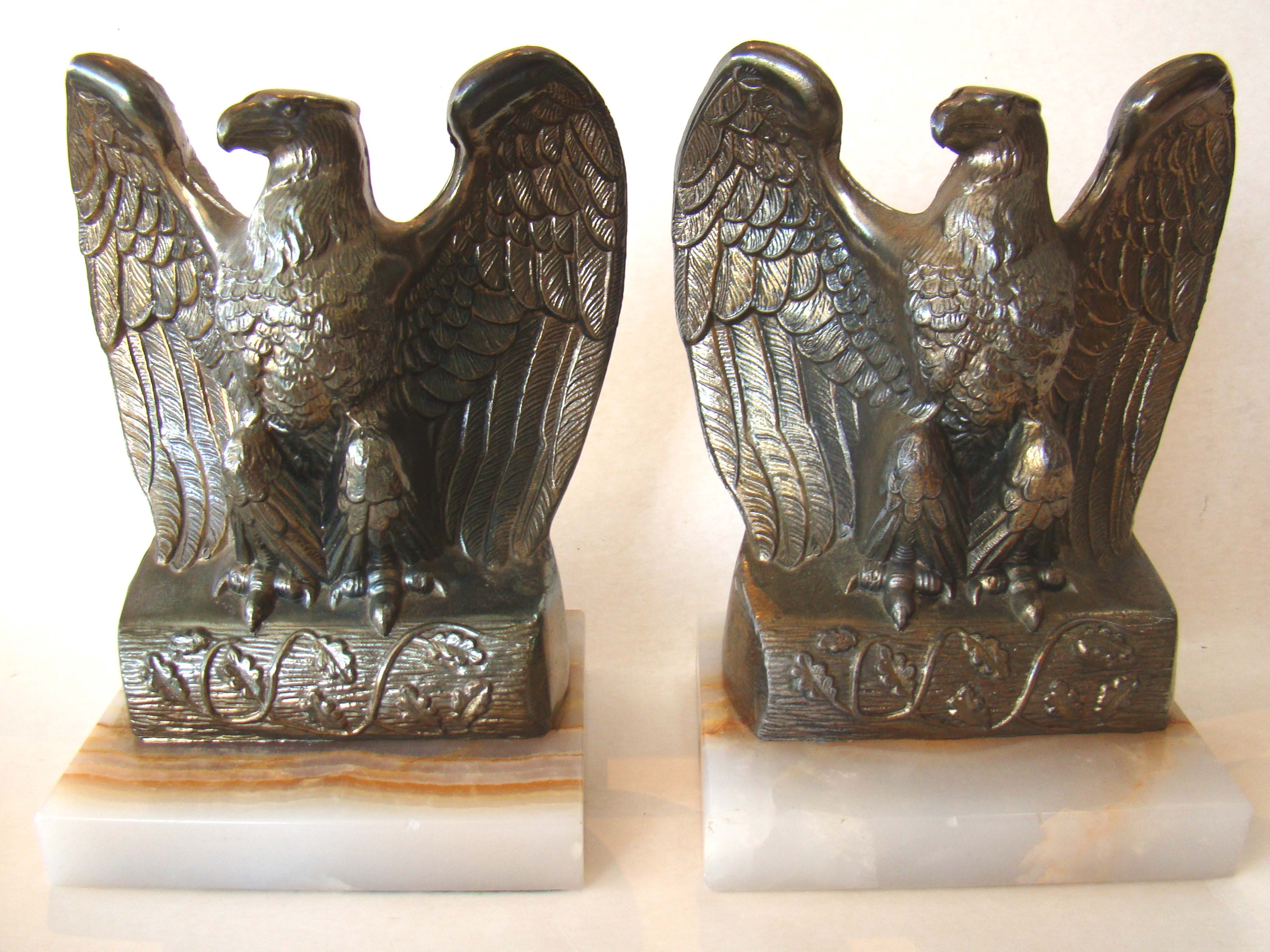 A pair of American spread wing eagle bookends on a marble base