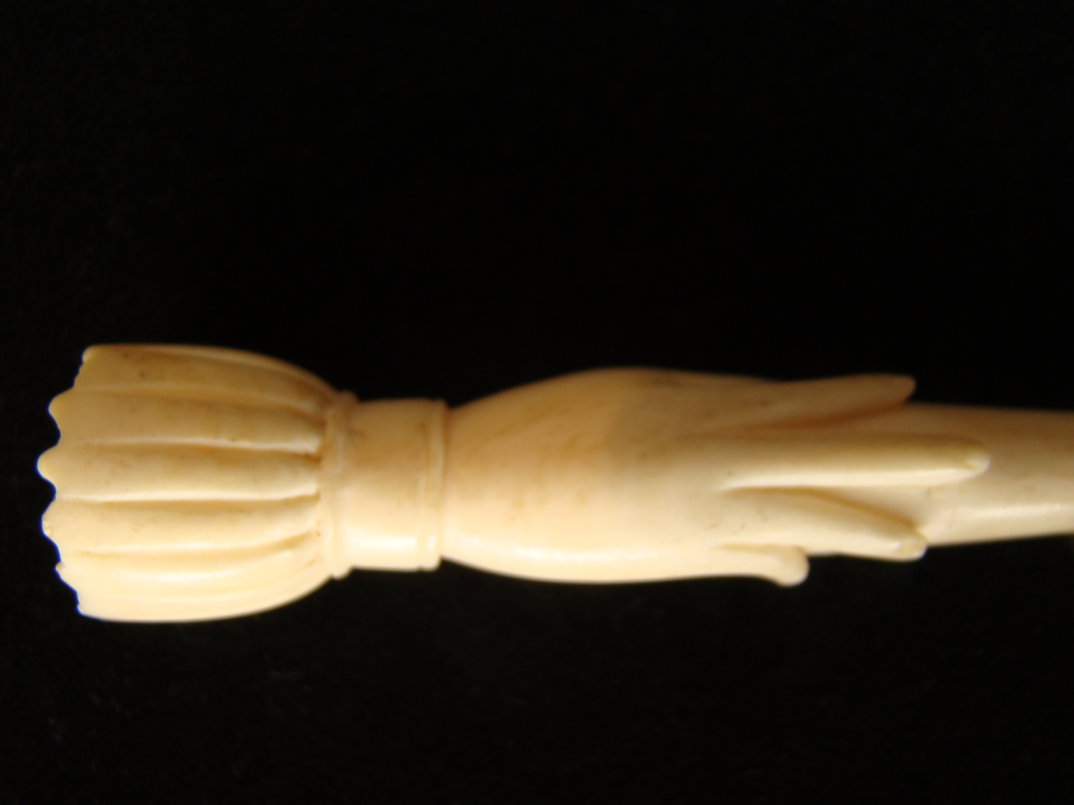 A fine and rare whale ivory bodkin  in the form of a hand holding a fid or bodkin circa 1850