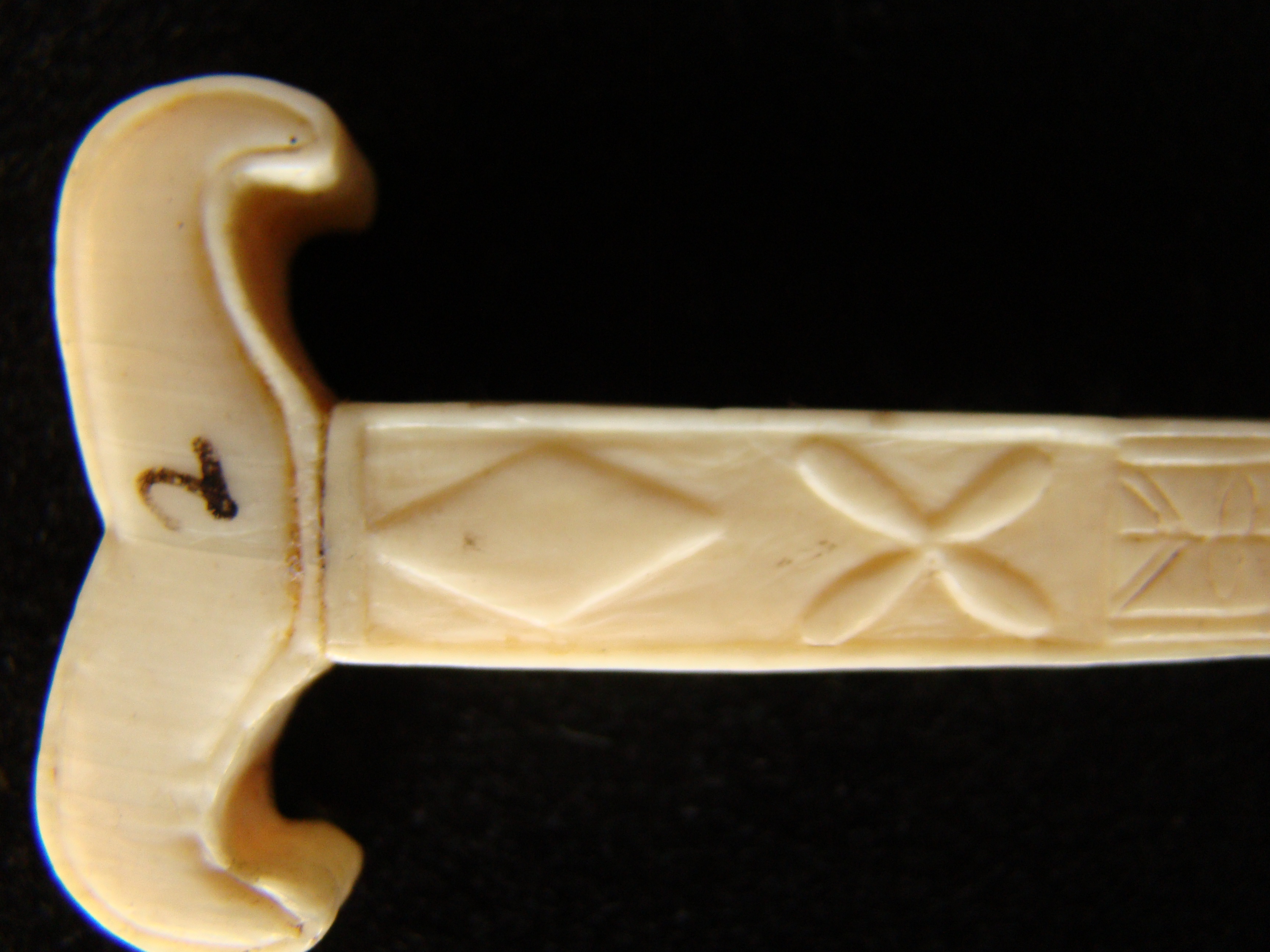 An unusual sailor-carved antique whale ivory bodkin in the form of a yoke circa 1850