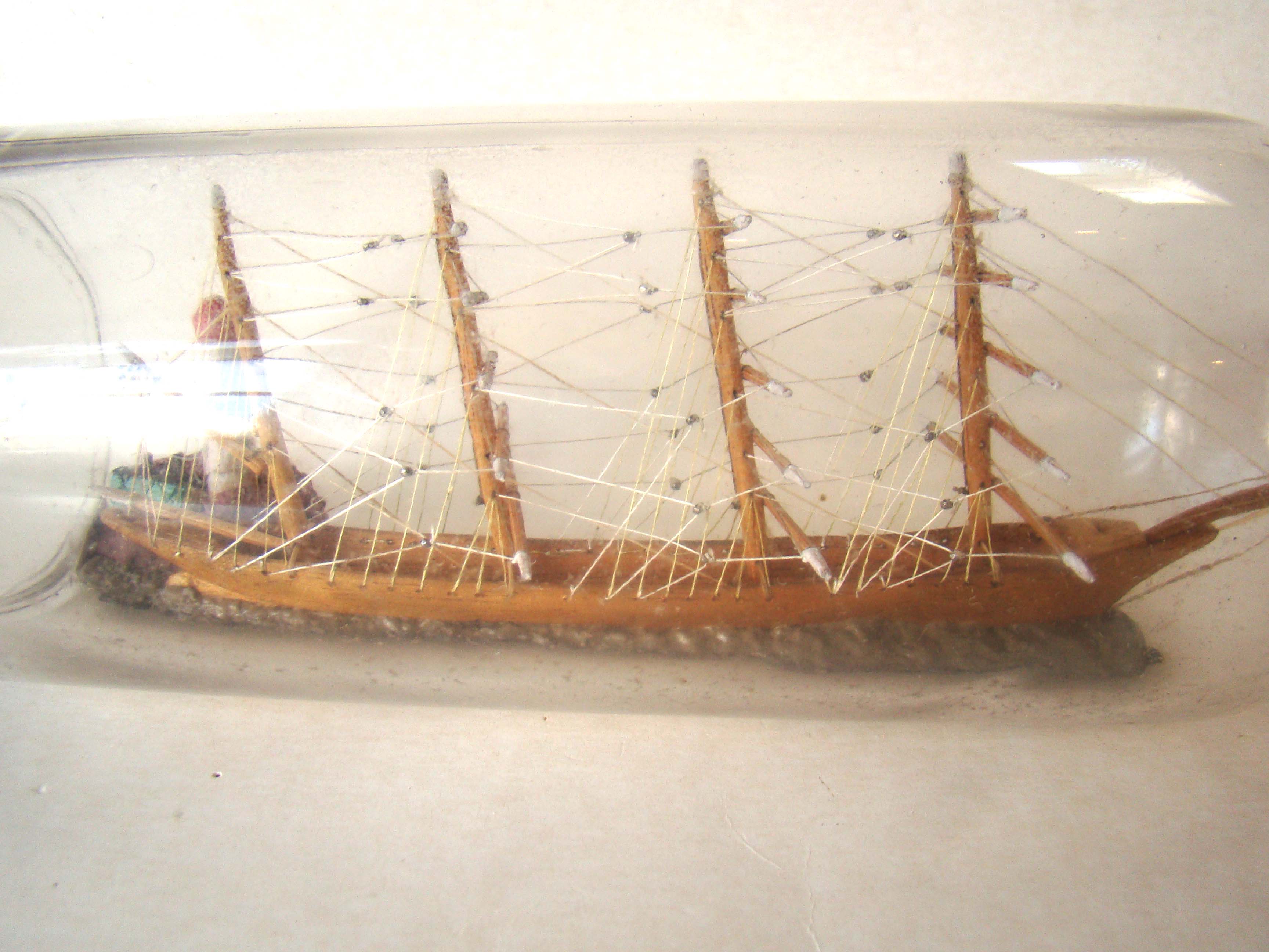 A fine vintage four-masted ship-in-a bottle circa 1930