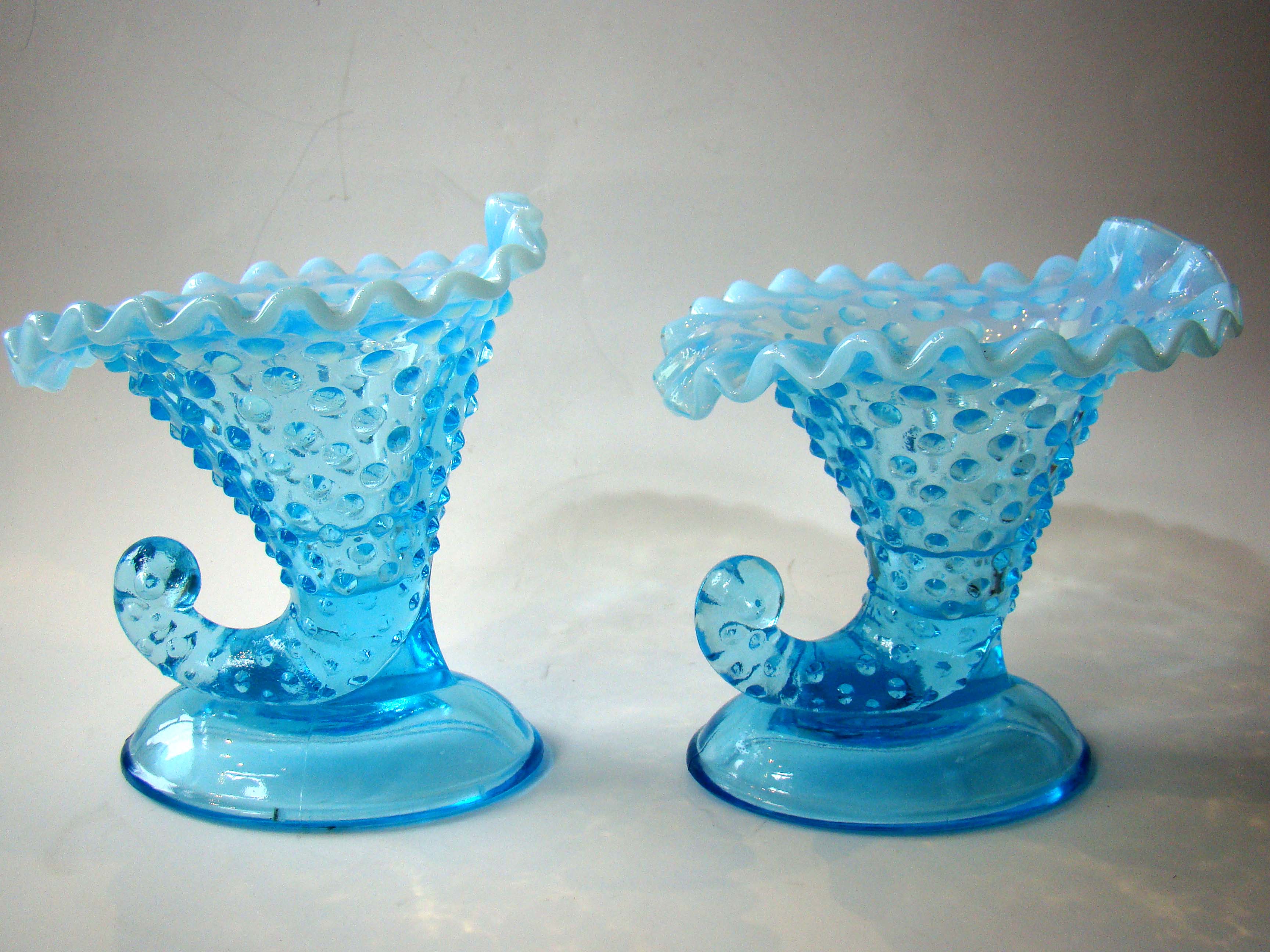 A beautiful pair of vintage aqua blue hobnail pattern cornucopia candle holders