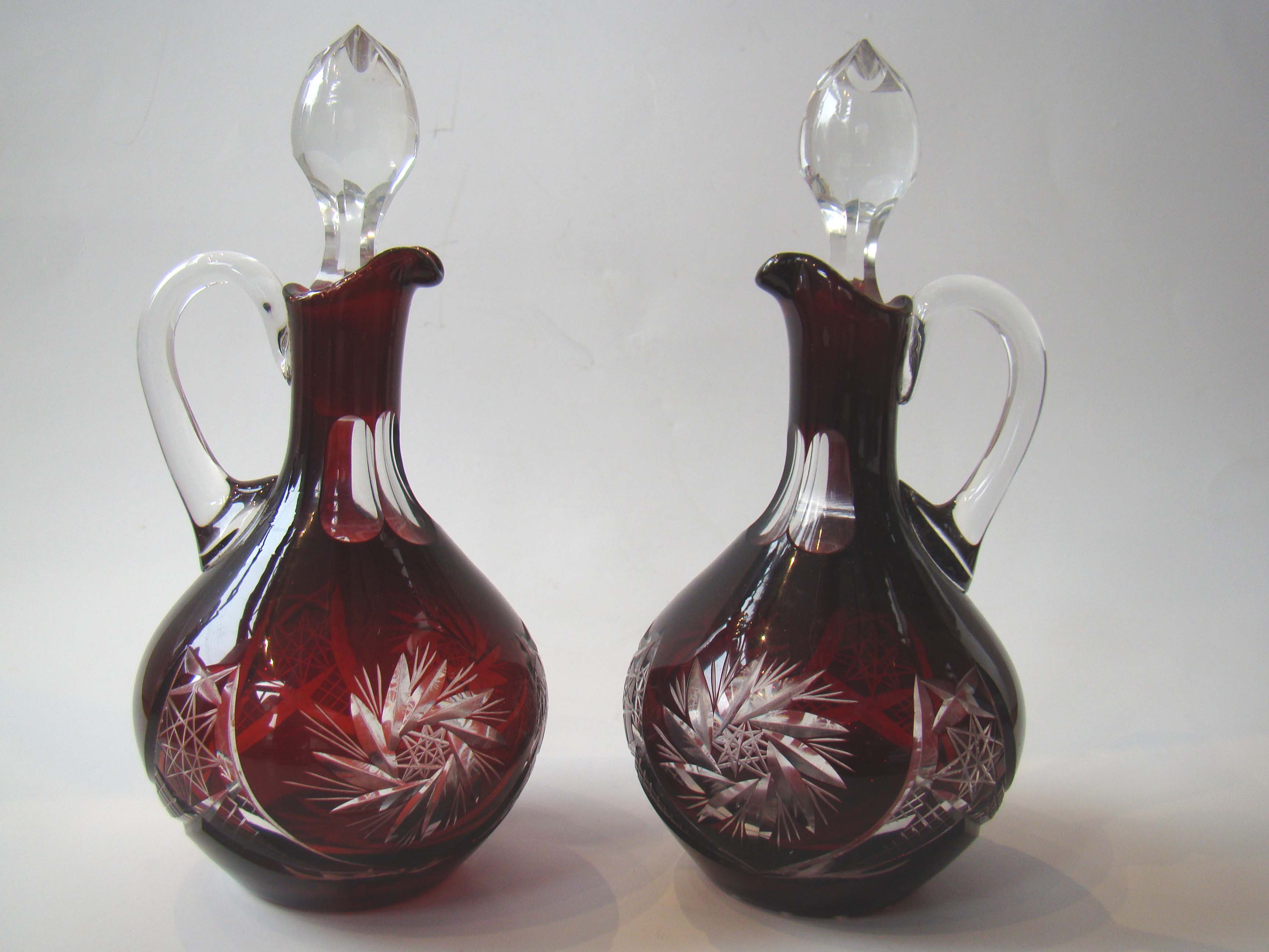 A fine pair of vintage ruby red cut glass cruet bottles circa 1890